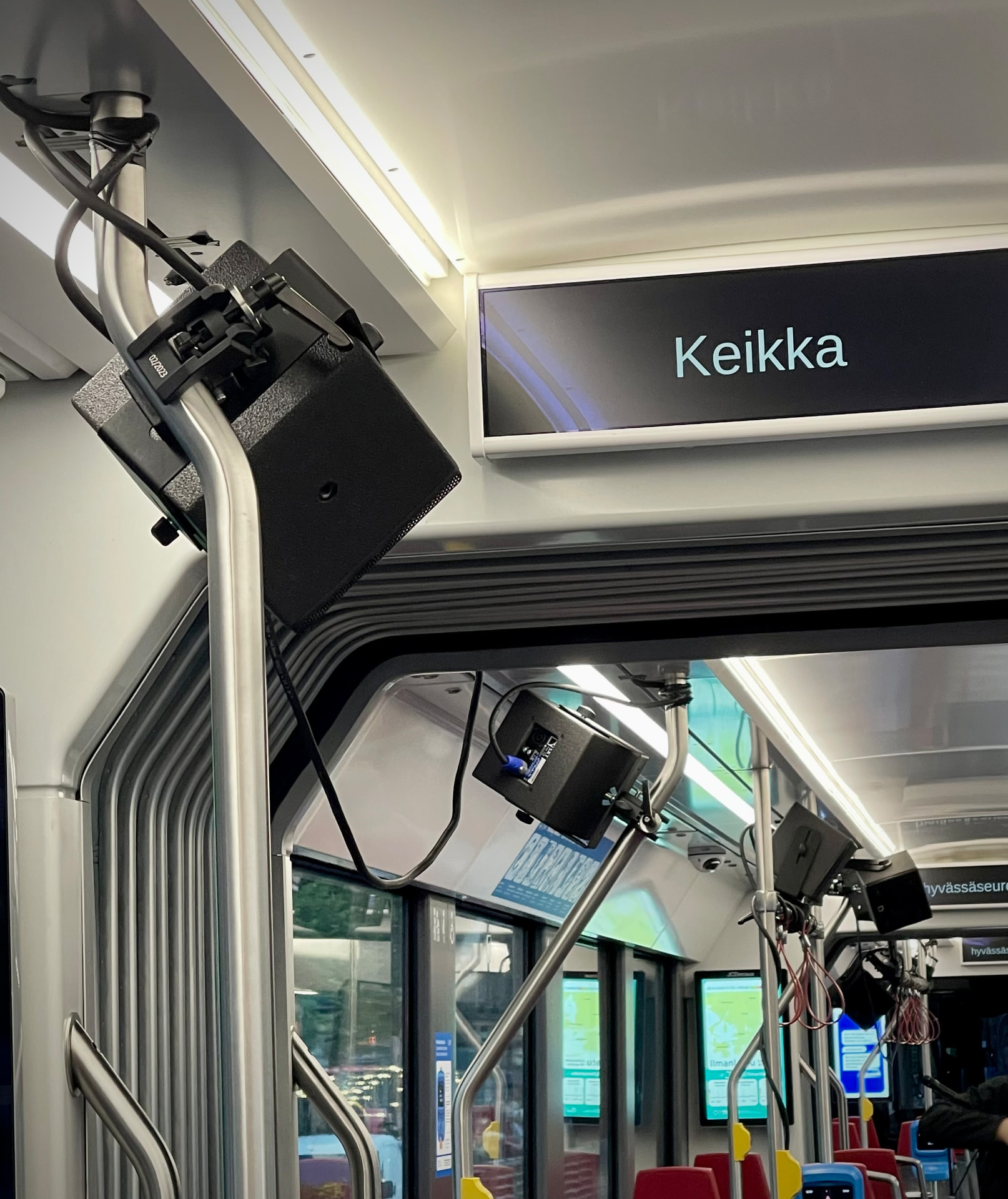 Gig tram speakers rigged to the tram's ceiling rails, with a display reading Keikka